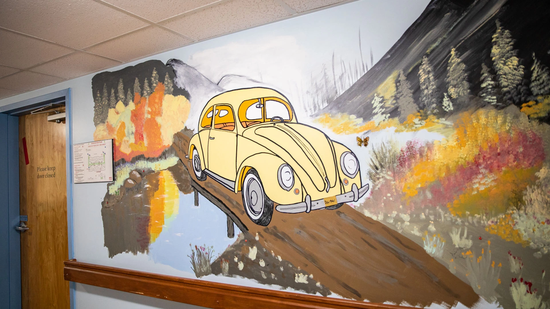 A painting of a car in forest on wall at The Hamlets at Penticton retirement home